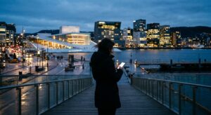 A professional, editorial-style photograph of a modern Norwegian cityscape at dusk with a blurred si