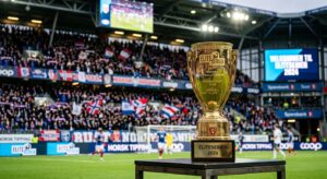 Professional editorial photograph of a blurred football stadium interior with a sharp, modern golden